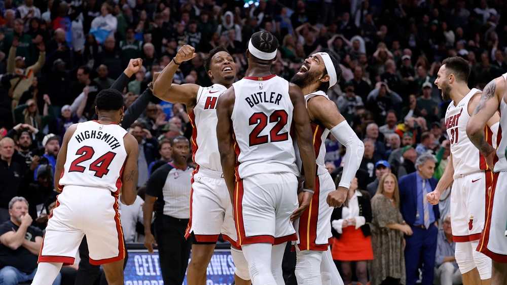 Miami Heat players celebrating in front of a crowd during thrilling Miami night events.