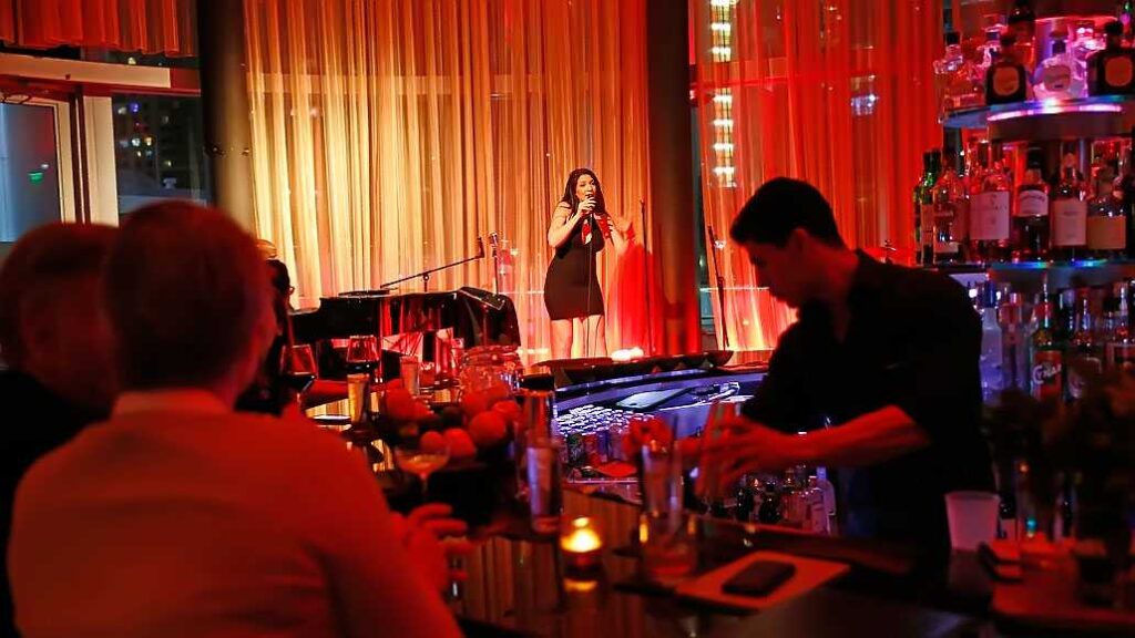 A woman performs at a bar during Miami night events.
