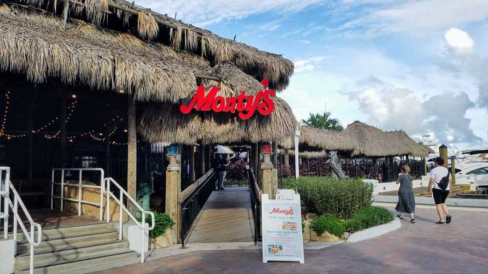 A beachfront restaurant with thatched roofs providing a perfect spot for Miami night events.
