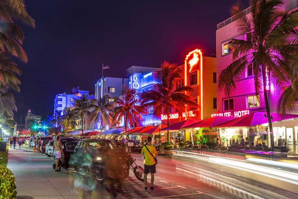 Things to do in Miami at night: Experience the vibrant nightlife of Miami, with its dazzling neon lights illuminating the palm tree-lined streets.