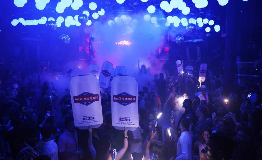 Nightclubs in Miami: A crowd of people holding signs at a nightclub in Miami.
