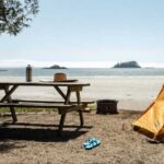 A yellow tent sits on the beach at a campgrounds on Vancouver Island.