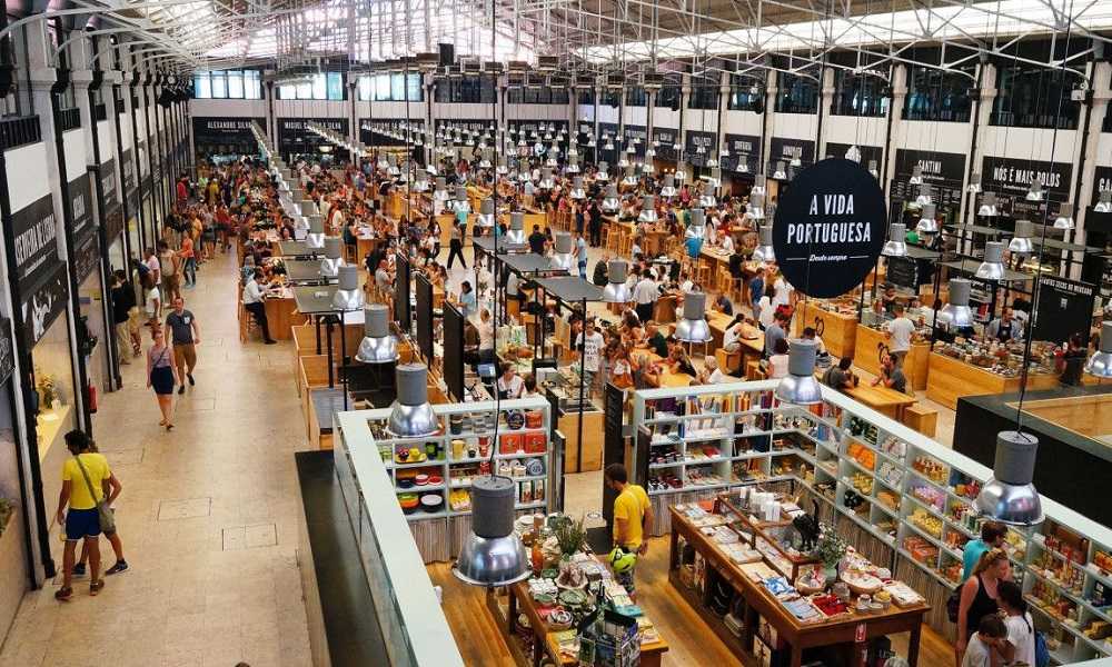 Mercado da Ribeira: A bustling indoor market with lots of people, perfect for exploring the best things to do in Lisbon.