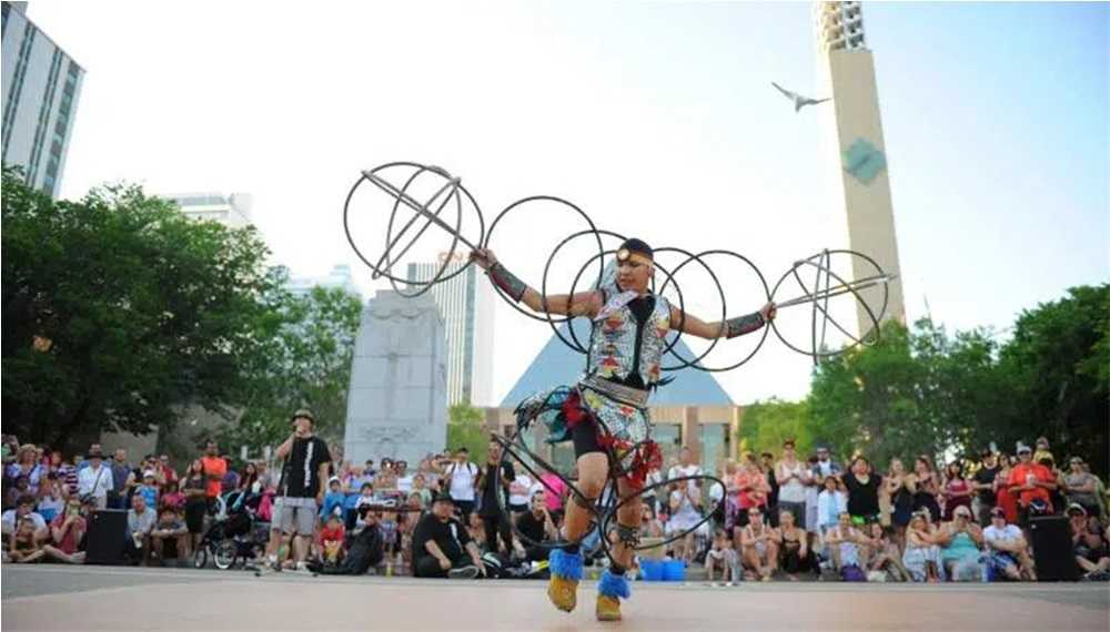 A man performing a hoop dance at festivals in Edmonton.