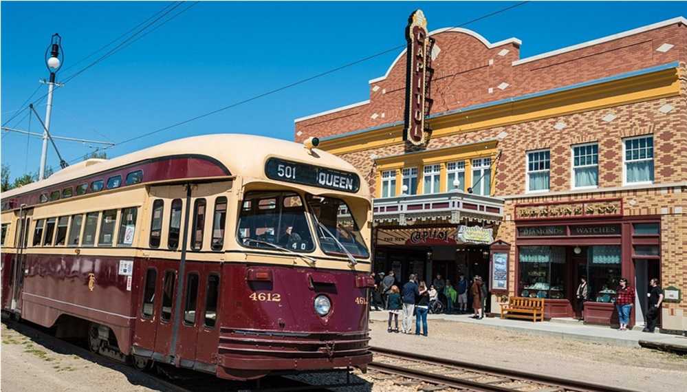 Fort Edmonton Park, Edmonton. A trolley car in front of a historic building, one of the many things to do in Edmonton.