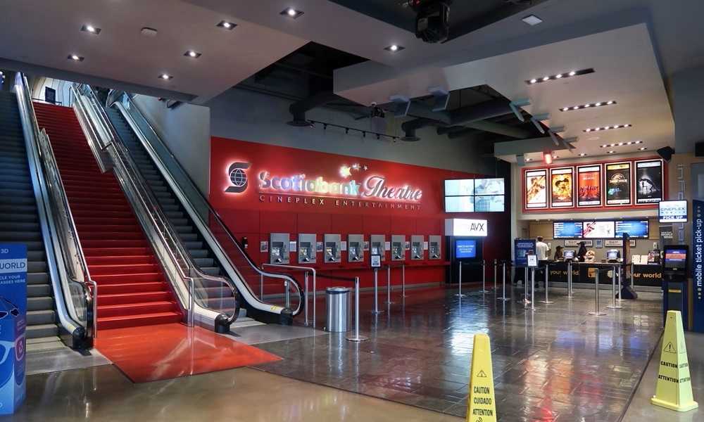 An extravagant movie theater in West Edmonton Mall featuring an escalator and a glamorous red carpet entrance.