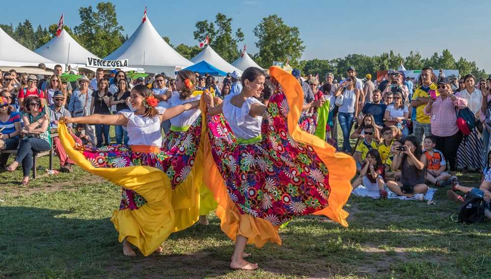         
Description: A group of dancers in colorful skirts perform at a festival in Edmonton.