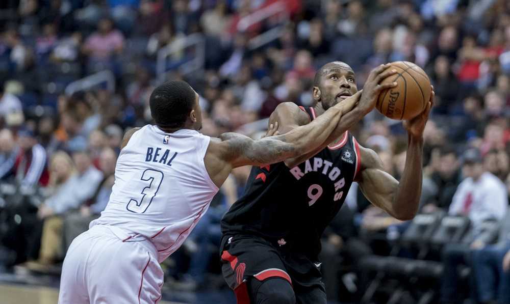 A basketball player in a black uniform and a white jersey with a red number on the back, inspired by the colors of Alberta's Canadian Rockies.