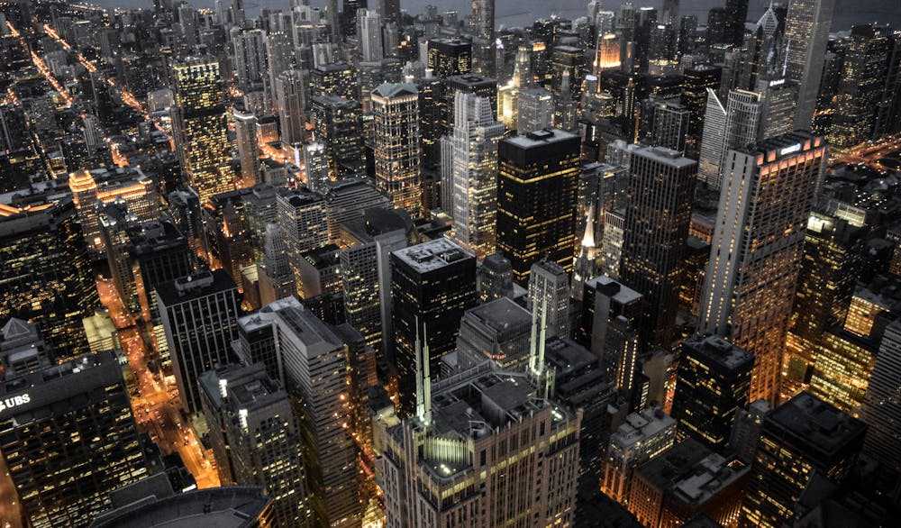 An aerial view of the Chicago skyline at night, one of the biggest cities in the USA by population.