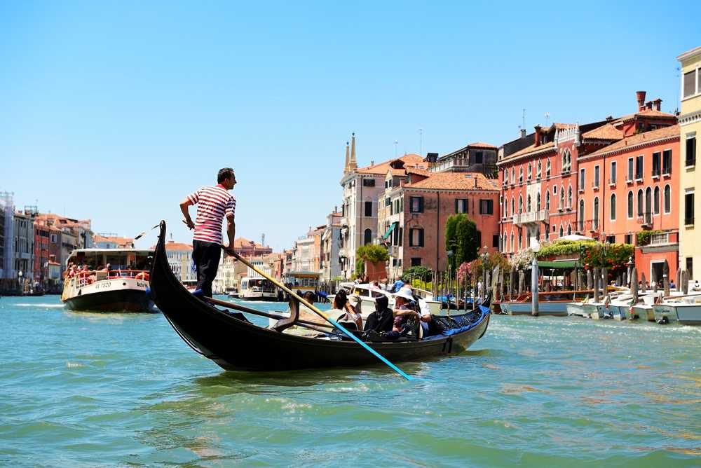 A gondolier staring Gondolas in Venice